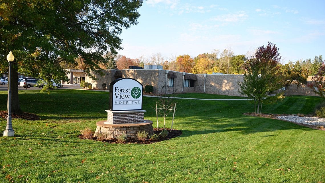View of the Forest View Hospital sign and open surrounding land